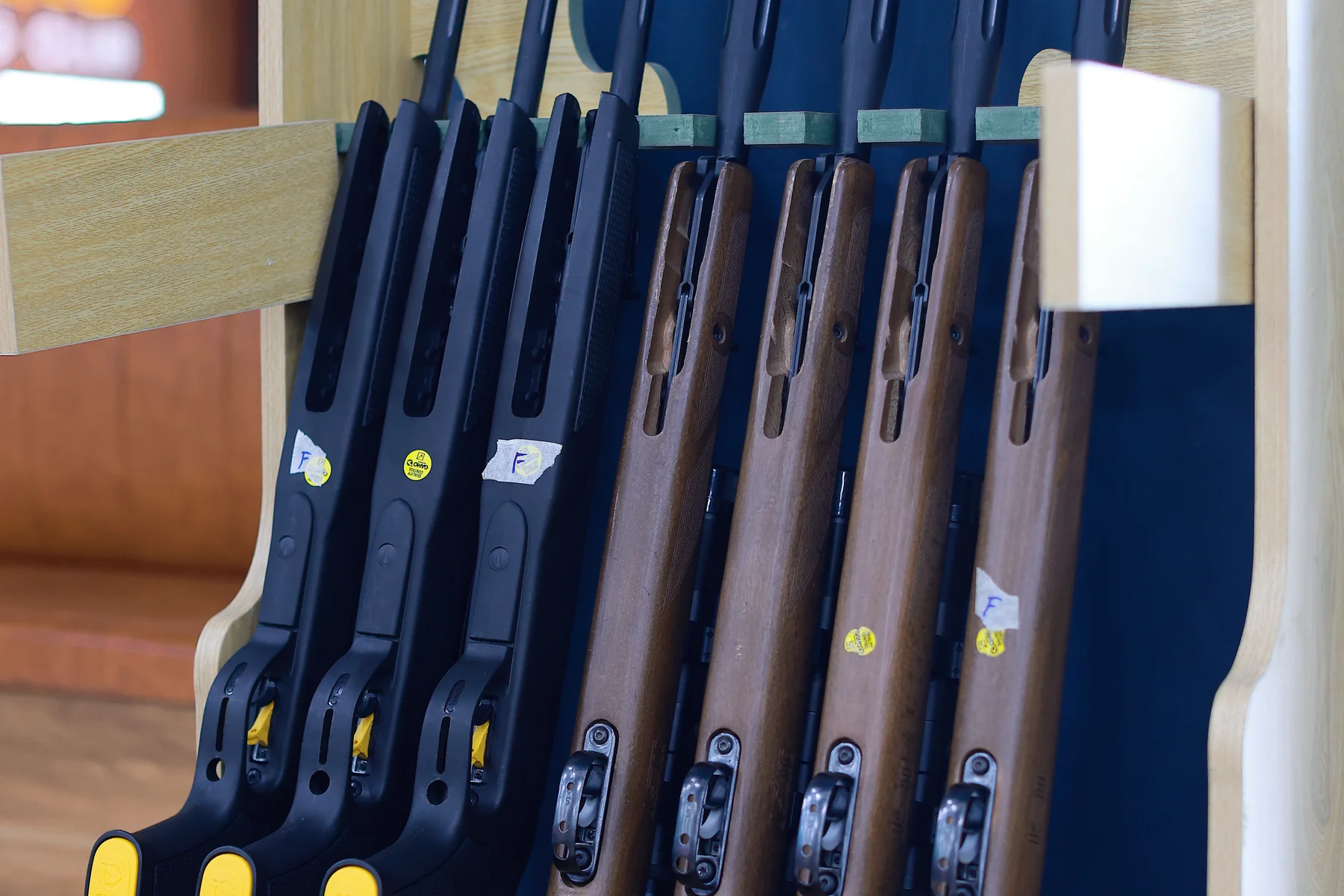 Vertical rack of sport rifles in pine holder